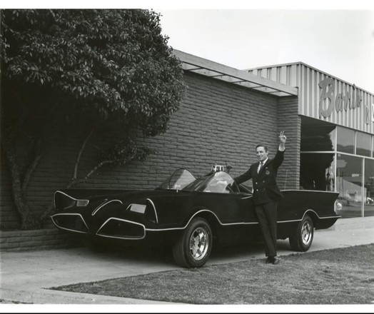 Batman creator Bob Kane at Barris Kustom City, posing for a photo with the number two Batmobile, circa 1970s.
