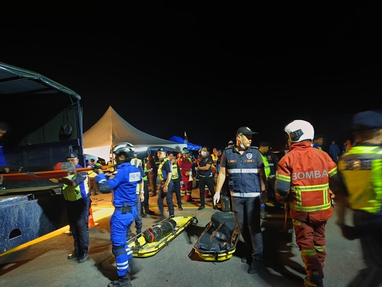 Various people handling various items using stretcher.