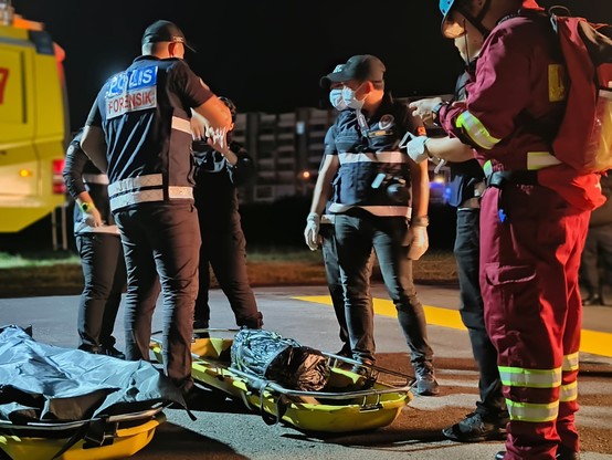 Various people handling various items using stretcher.