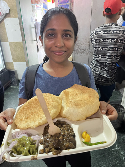 Ruchika with a very big smile and an even bigger plate of Chole Bhatura. 