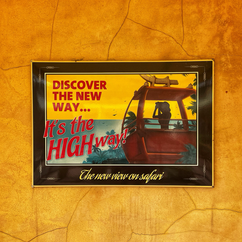 Photo of stylised illustrated poster for Safaribanan. Text reads: “Discover the new way… It’s the high way! The new view on Safari”