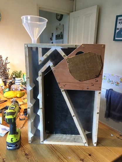 A DIY seed cleaning machine - seeds are poured into a funnel and a vacuum cleaner whooshes them around a series of tunnels separating the seed from the chaff