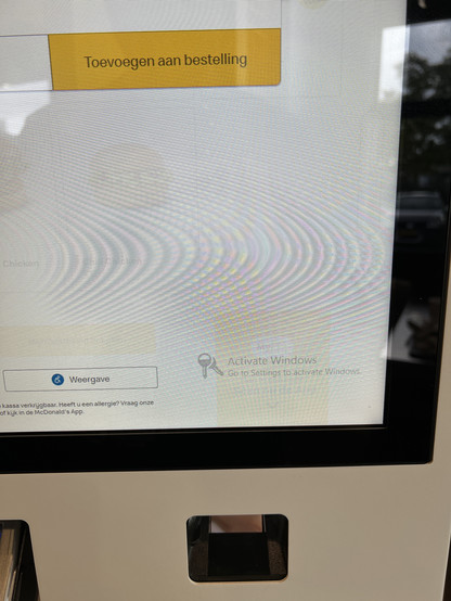 Photo of an ordering terminal at McDonald’s with a message telling to activate the windows install.