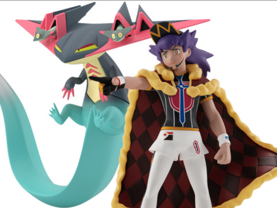 two action figures, one with large flat head and lizard body, another with a cape, purple hair, and hat on 