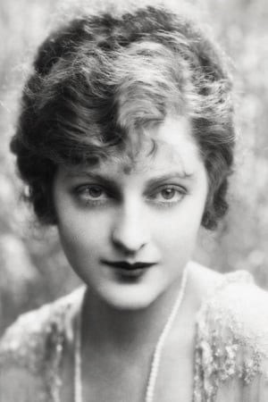 Black and white portrait photo of actress Eleanor Audley in the 1920s. She has short, medium dark hair; medium dark eyes; a Cupid's bow mouth; and a pleasant but almost sultry look on her face. Her makeup is 1920s style, and her clothing is frilly and white.