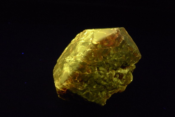 A glowing golden luminous crystal appears to sit floating in dark space.