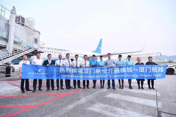 A group of staff of Xiamen Airlines celebrating the aircraft arrival.