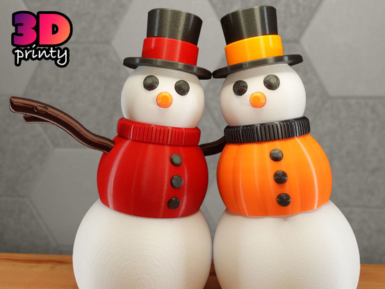 Photo of two 3D printed giant snowpeople.

The one on the right is wearing a red sweater and a black top hat with a red band.

The one on the left is wearing a pumpkin vest and a black top hat with an orange band.
