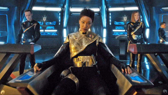 Michael Burnham as her Terran counterpart, sitting in the captain's chair and staring at the camera, in S1Ep11 THE WOLF INSIDE