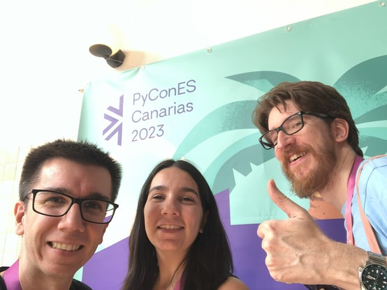 Selfie of three people with the logo of PyConES Canarias 2023