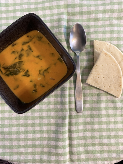 Bowl of tomato soup with spinach, chickpeas and pasting