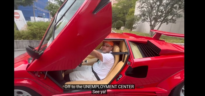 Hideki Kamiya formerly of PlatinumGames, Clover Studio, and Capcom in a red Lamborghini Countach with door open