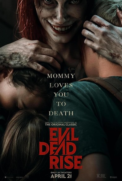 Movie poster for "Evil Dead Rise". Showing a woman with cuts/bruises on her face, red hair and a demonic smile holding on to her 3 children with their faces buried in her chest and waist. 