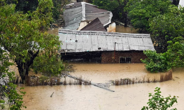 Houses submerged in floodwater in Blantyre, Malawi, in March 2023.
Houses submerged in floodwater in Blantyre, Malawi, in March. Photograph: Thoko Chikondi/AP