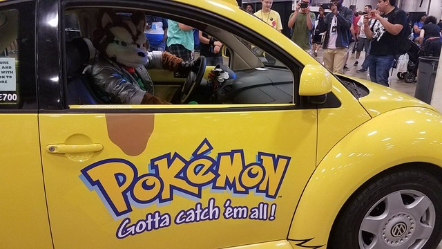 Fox McCloud in the driver's seat of a Pikachu-shaped Volkswagon Beetle.