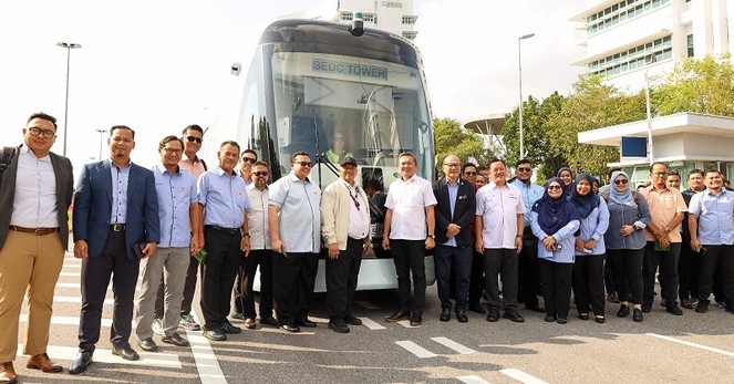 Delegates from Selangor state government posing for a group photo in front of ART vehicle.