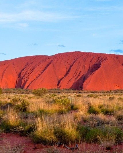 Big rock of Uluru or Ayer Rock in Australia turning so red when the sun sets.