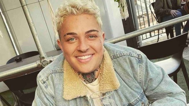 Photo of a non-binary person with short blonde hair