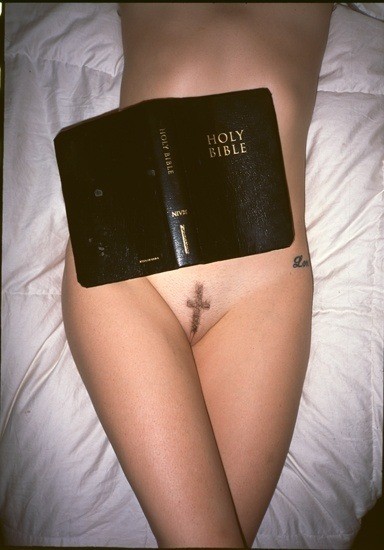 Bible ontop of belly
pubes shaved into shape of cross
