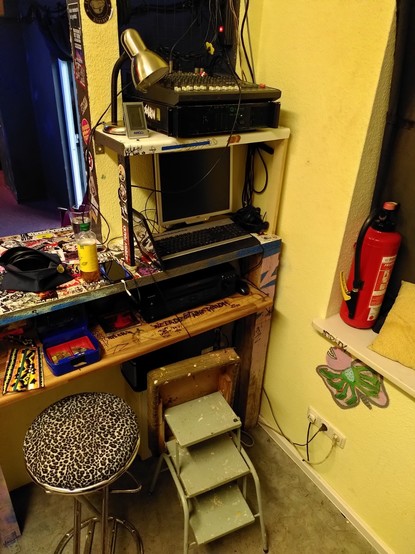 Corner of the bar, with a little ladder leading to the mixing desk on top of a shelf