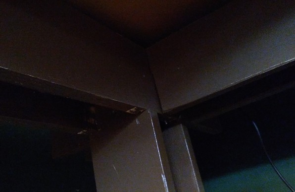 The dim underside of the desk with a couple of support rails for the 3/4 inch MDF top