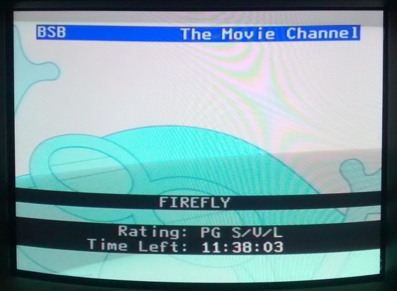 Photograph of a TV showing programme information.