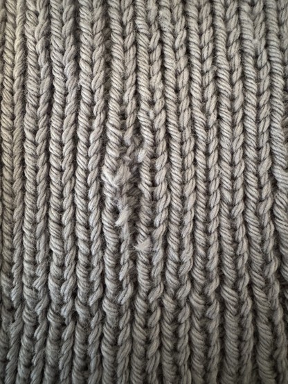 Closeup of torn knitted stitches 