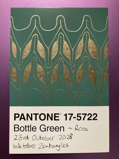 Gold ink pattern on a bottle green background