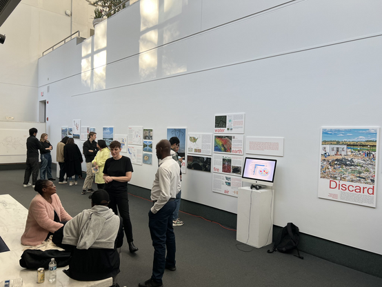 A pic of an exhibit tour. People mingling and looking at the exhibit. 