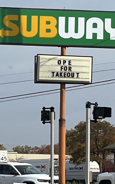 A roadside sign for Subway with the caption “ope for takeout”