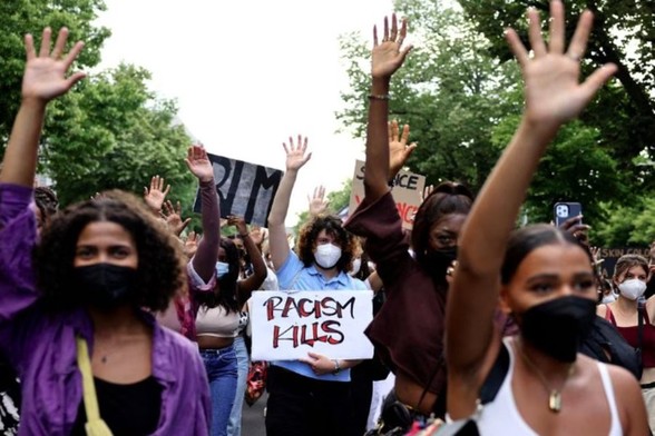 A demonstrator holds a placard reading "Racism Kills" during a Black Lives Matter protest in Berlin, Germany, July 2, 2021. 
File| REUTERS| Christian Mang|