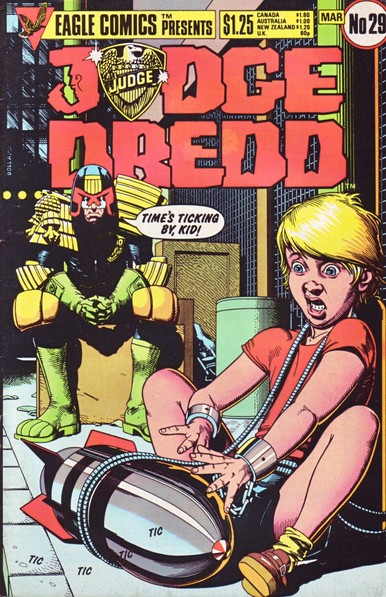 The front cover of Judge Dredd, Vol 1, No 29 from March 1986, featuring an illustration by Brian Bolland of a young lad chained to a ticking time bomb while Joe Dredd says "Time's ticking by, kid!".