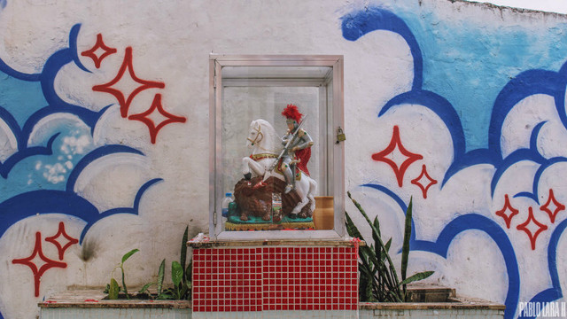 Saint George statue killing the dragon on a glass display at Lapa arches.