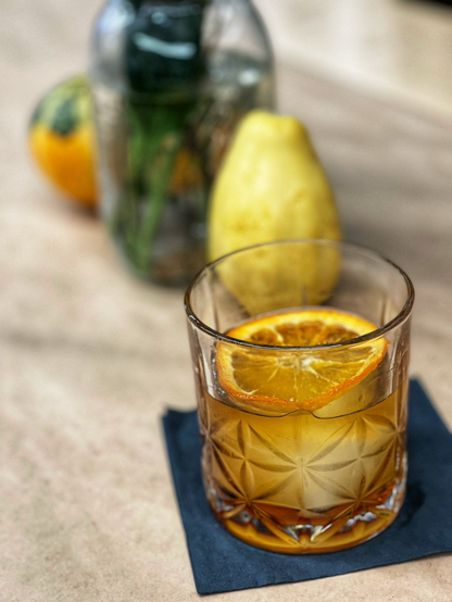 A sassafras old fashioned on a table.