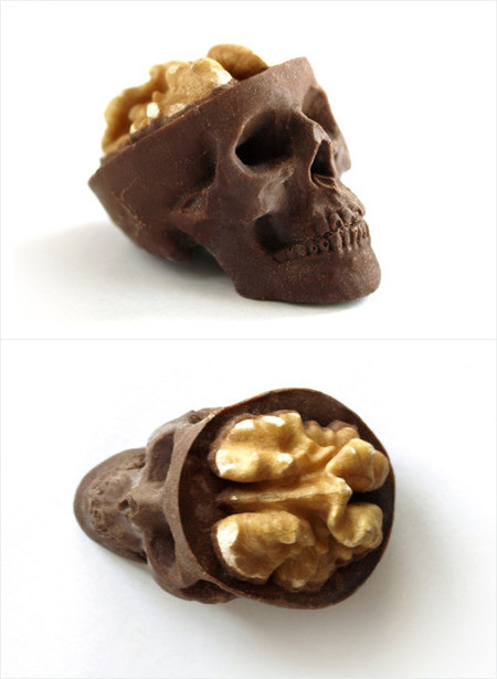 Eine Walnuss simuliert, ein Gehirn zu sein – sie steckt in einem Totenschädel aus Schokolade.
