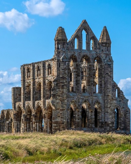 Whitby Abbey Monastery in Whitby, England, is a hauntingly beautiful ruin on a cliff overlooking the North Sea, and it is famously associated with Bram Stoker's Dracula.