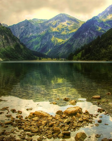 Vilsalpsee in the Allgäu region of Germany is a pristine Alpine lake surrounded by lush meadows and rugged peaks, offering a serene and picturesque natural retreat.