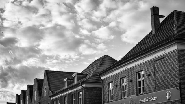 Roofline of Flying Dutchman restaurant and neighboring Dutch-style brick buildings, Dutch Quarter, Potsdam, 16 Oct 2023