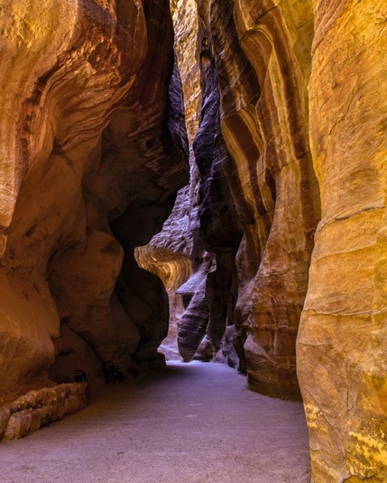 Al Siq canyon in Petra, Jordan, is a dramatic natural corridor leading to the ancient city, featuring intricate rock formations and hidden secrets waiting to be discovered