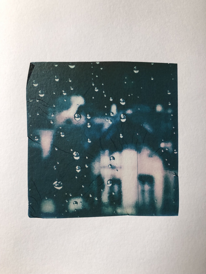 Close-up of rain drops on a window. Polaroid emulsion lift.