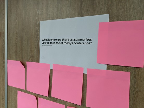 "Write words on this paper" to provide session feedback, on the wall outside the room 