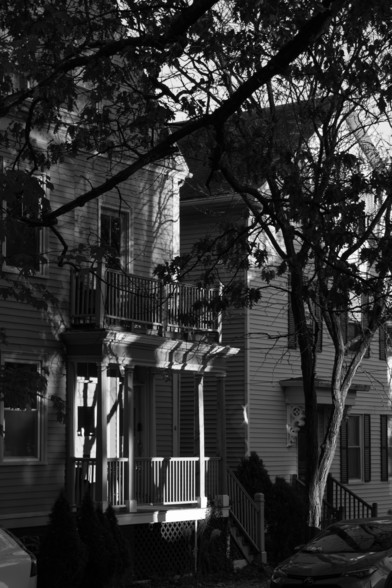 Dramatic lighting as the sun sets on a quiet street in Providence RI, in black and white