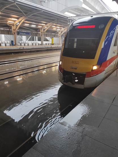 KTM Komuter train at Subang Jaya station with the train track flooded. / Photo by ilhamalbakerr from the embed in the article linked.