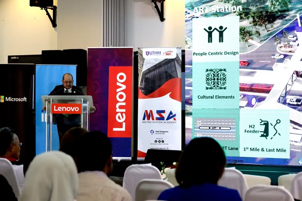 A person presenting the design of ART station in front of a group of people.