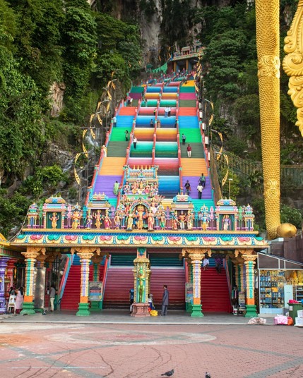 The Batu Caves in Malaysia, a series of natural limestone caverns, are famous for their vibrant Hindu shrines and the challenging 272-step climb to the main cave