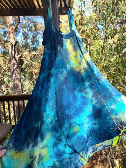Picture of the dress in the sun, showing the flowy skirt, and dyed turquoise, teal, navy, and bright green