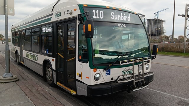 Durham Region Transit 6126, which is a Novabus LFS HEV. It has the regular livery, but also a DRT Hybrid logo of the side. The destination signs read "110 Sunbird".