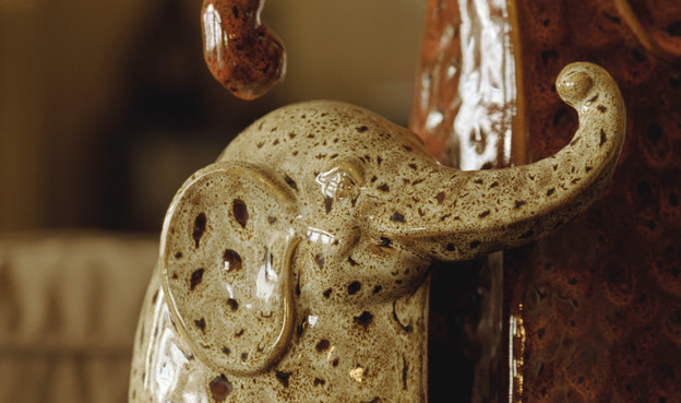 Close-up photo of ceramic bookends shaped like elephants.