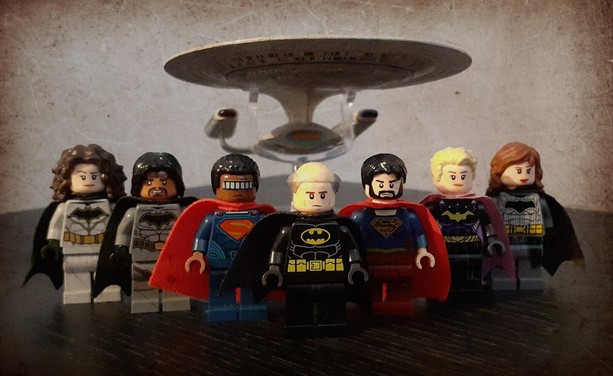 LEGO Star Trek/Justice League mashup minifigures. From left to right:

Troi/Batman
Worf/Batman
La Forge/Superman
Picard/Batman
Riker/Supergirl
Yar/Batgirl
Crusher/Batman