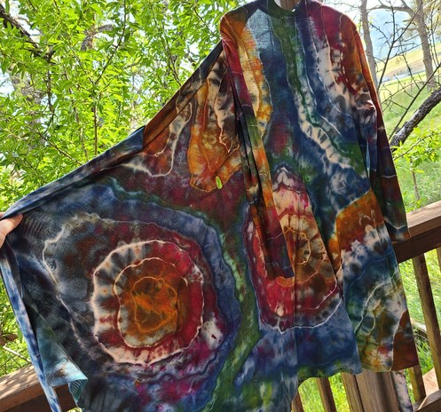 A knee length, flowy cardigan dyed in earth tone rainbow shades, in an organic free-form geode gemstone pattern